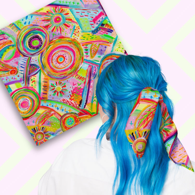 Two views of the 'Summer Sorbet' Bandana by My Favourite Colour is Rainbow.  At top left, a flat lay of the bandana.  At bottom right, a person with vibrant blue hair is seen from behind, wearing the bandana in her hair.  The bandana features a colourful abstract design with swirling circles, geometric shapes and doodle-like details in hues of pink, yellow, blue, green, orange, and red.