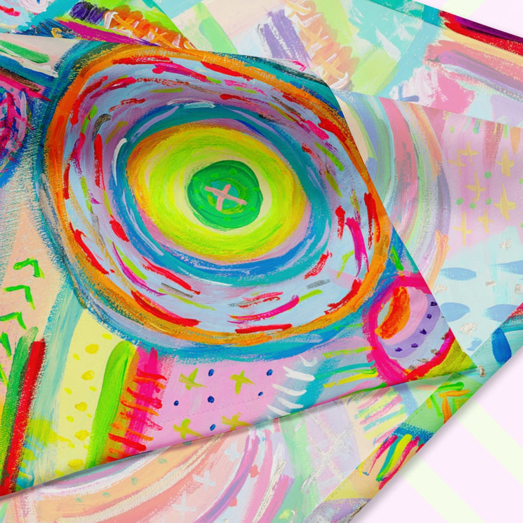 A closeup of the 'Summer Sorbet' Bandana by My Favourite Colour is Rainbow featuring a colourful abstract design with swirling circles, geometric shapes and doodle-like details in hues of pink, yellow, blue, green, orange, and red. The design is printed on only one side of the bandana.