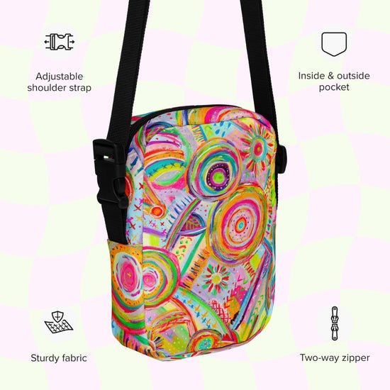 An infographic highlighting features of the Summer Sorbet Mini Crossbody Bag by My Favourite Colour is Rainbow: adjustable shoulder strap, inside and outside pocket, sturdy canvas fabric and a two-way zipper.