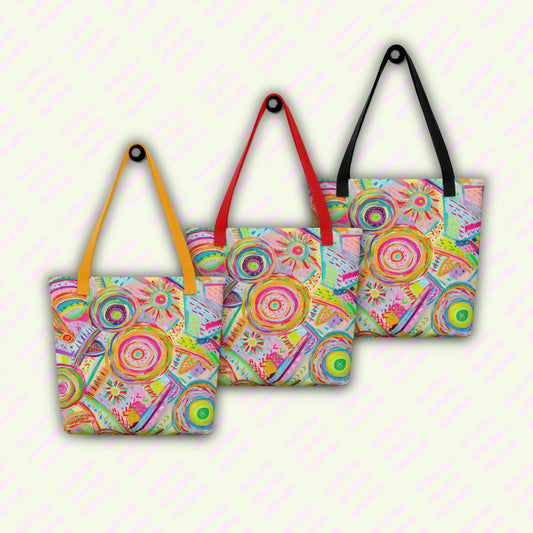 Three Summer Sorbet Tote Bags by My Favourite Colour is Rainbow are lined up on a light background with diagonal pink stripes. Each spacious tote features my Summer Sorbet painting: colourful, abstract circular designs and different coloured handles: yellow, red, and black.