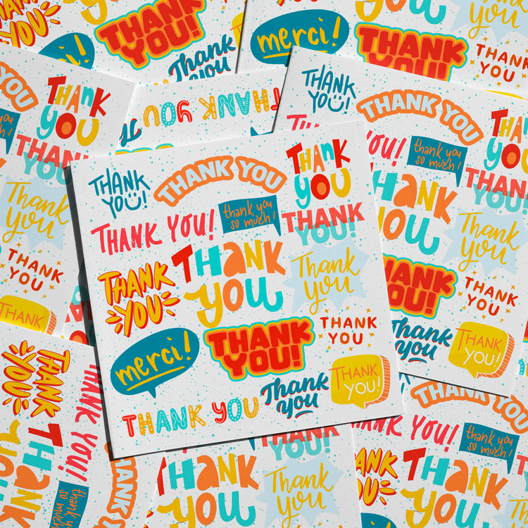 The Thank You Typography Card from My Store features a vibrant, cheerful design with a collage of colorful Thank You and Merci texts in various fonts and sizes on overlapping papers.