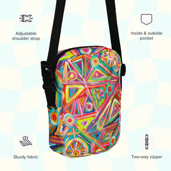 An infographic highlighting features of the Tropical Geometry Mini Crossbody Bag by My Favourite Colour is Rainbow: adjustable shoulder strap, inside and outside pocket, sturdy canvas fabric and a two-way zipper.