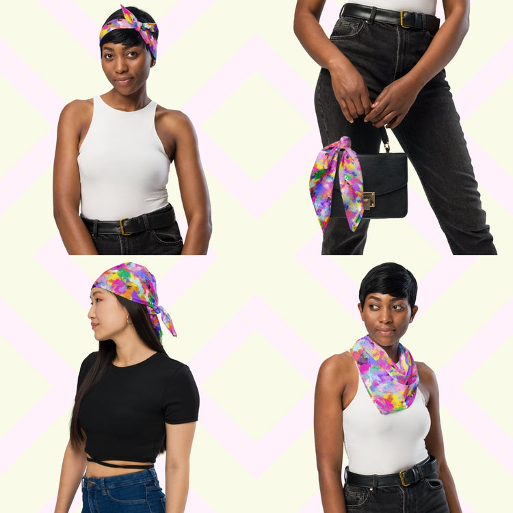 Four women show off the 'Watercolour Rainbow' Bandana by My Favourite Colour is Rainbow.  They style it as a headband, necktie, handbag accessory, and headwrap while in casual outfits. The bandana features a vibrant abstract design with blue, green, pink, orange, and purple splashes.