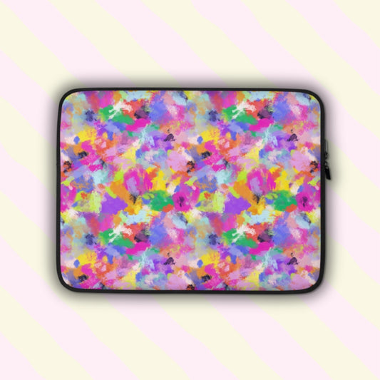 The Watercolour Rainbow Laptop Sleeve by My Favourite Colour is Rainbow features a vibrant abstract pattern with pink, purple, blue, yellow, and green splashes.  The print is on only one side of the laptop sleeve, the other side is black.