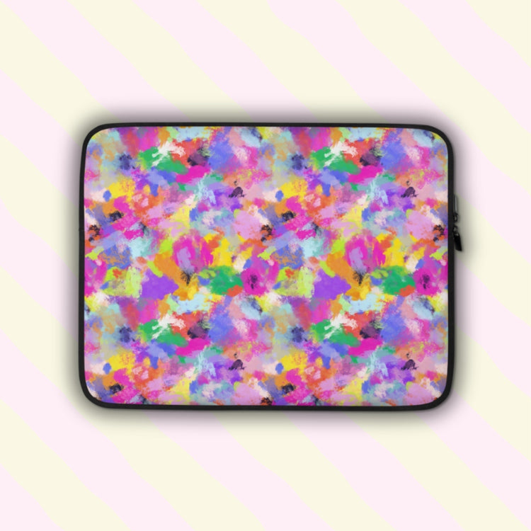 The Watercolour Rainbow Laptop Sleeve by My Favourite Colour is Rainbow features a vibrant abstract pattern with pink, purple, blue, yellow, and green splashes.  The print is on only one side of the laptop sleeve, the other side is black.
