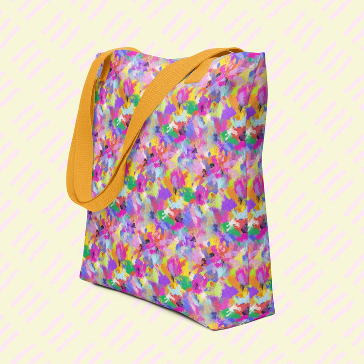 The Watercolour Rainbow Tote Bag by My Favourite Colour is Rainbow, made from durable polyester, features an abstract multicoloured pattern in pink, yellow, blue, and purple. It features dual yellow handles.