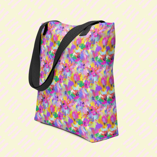 The Watercolour Rainbow Tote Bag by My Favourite Colour is Rainbow, made from durable polyester, features an abstract multicoloured pattern in pink, yellow, blue, and purple. It features dual black handles.