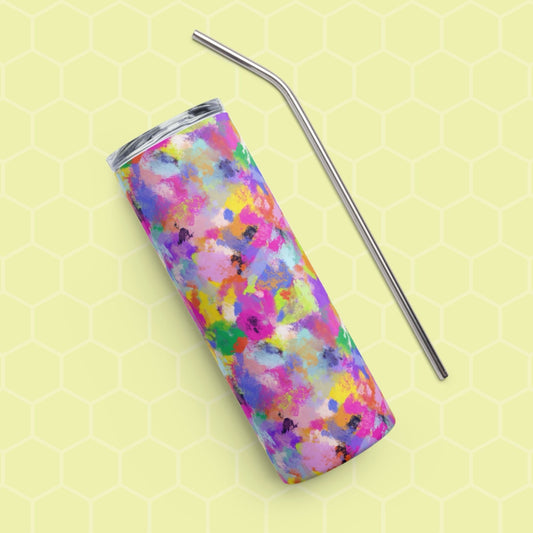 On a light yellow hexagonal pattern background, the vibrant Watercolour Rainbow Stainless Steel Tumbler by My Favourite Colour is Rainbow features an abstract paint splatter design with a metal straw placed diagonally beside the reusable tumbler.