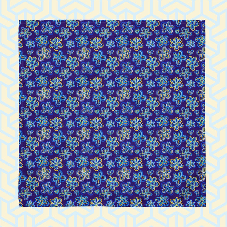 A Bloomscape Napkin by My Favourite Colour is Rainbow, featuring a design of large flowers and small hearts in shades of blue and yellow on a royal blue background.