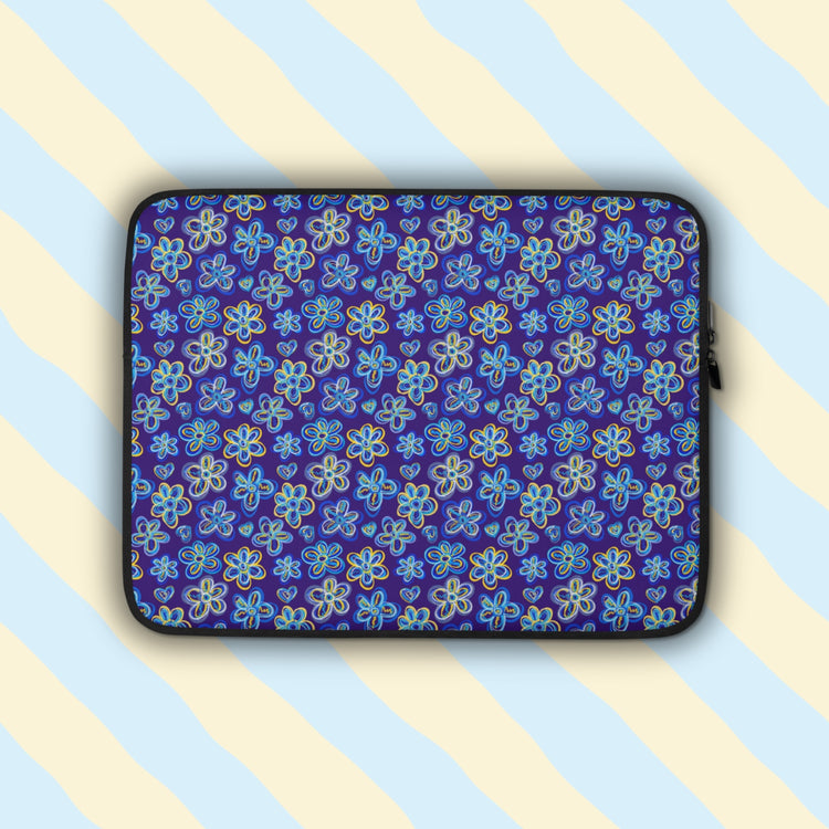 The Bloomscape Laptop Sleeve by My Favourite Colour is Rainbow features a design of large flowers and small hearts in shades of blue and yellow on a royal blue background. It has a with a plush grey faux fur interior, and black binding and rear side.