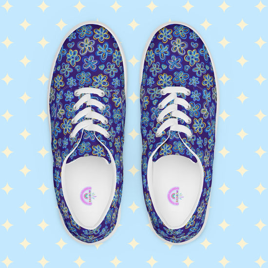 Introducing Bloomscape Canvas Sneakers from My Favourite Colour is Rainbow: vibrant lace-up shoes with a colourful blue and yellow floral pattern on a royal blue backdrop. They feature white laces, breathable lining, and white soles.