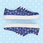 Introducing Bloomscape Canvas Sneakers from My Favourite Colour is Rainbow: vibrant lace-up shoes with a colourful blue and yellow floral pattern on a royal blue backdrop. They feature white laces, breathable lining, and white soles.  Shown on their sides