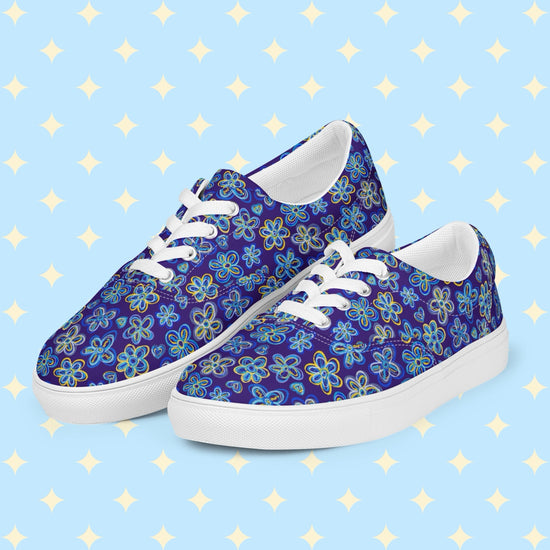 Introducing Bloomscape Canvas Sneakers from My Favourite Colour is Rainbow: vibrant lace-up shoes with a colourful blue and yellow floral pattern on a royal blue backdrop. They feature white laces, breathable lining, and white soles.