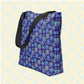 The Bloomscape Tote Bag by My Favourite Colour is Rainbow features floral and heart patterns in yellow and blue on a blue base.  It has black handles.