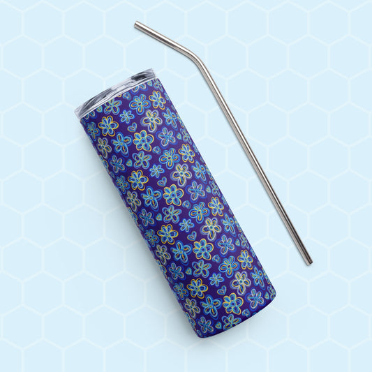 A Bloomscape Stainless Steel Tumbler by My Favourite Colour is Rainbow, featuring a design of large flowers and small hearts in shades of blue and yellow on a royal blue background shown on its side with a matching metal straw. 