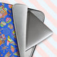 A laptop peeks out from the Blue Summer Sorbet Laptop Sleeve by My Favourite Colour is Rainbow, featuring cut outs of my Summer Sorbet print in a fun mix of suns, rainbows, ice creams and other abstract shapes, against a striking blue backdrop