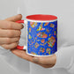 A person holds the Blue Summer Sorbet Mug by My Favourite Colour is Rainbow, featuring vibrant abstract fish against blue, with a contrasting red interior and handle. Dressed in a white top with manicured nails, they embody the perfect summer escape.