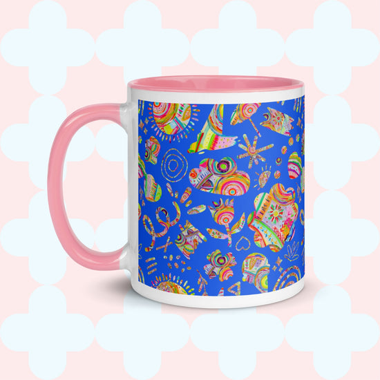 Enjoy a summer escape with the My Favourite Colour is Rainbows Blue Summer Sorbet Mug, featuring a pink handle, interior, and a vibrant design of hearts, swirls, and abstract shapes on a light teal cloverleaf background.