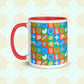 The Colour Block Mug from My Favourite Colour is Rainbow features a red handle and rim, a geometric design with vibrant blue, green, red, and orange shapes and symbols on a light cloud-patterned backdrop.