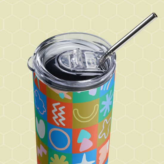 The Colour Block Stainless Steel Tumbler by My Favourite Colour is Rainbow features a vibrant pattern of stars, hearts, and squiggles with a metal straw and clear lid—ideal for stylish and eco-friendly sipping.