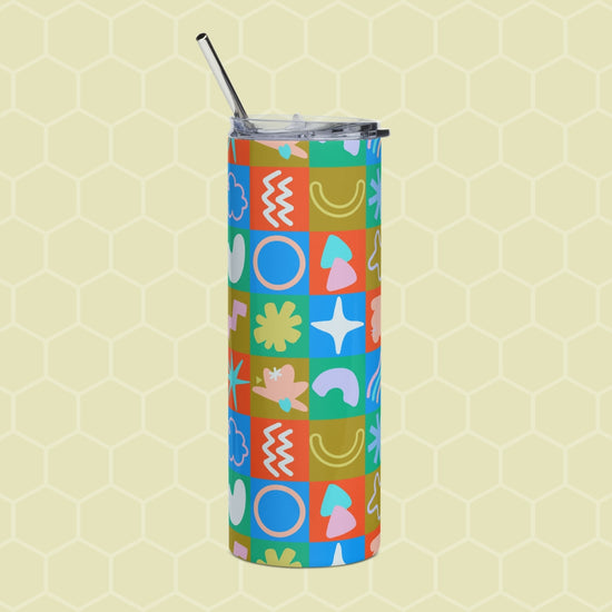 The Colour Block Stainless Steel Tumbler from My Favourite Colour is Rainbow stands against a honeycomb-patterned background. It features vibrant geometric and abstract designs, displaying circles, wavy lines, and floral motifs in red, blue, green, and pink.