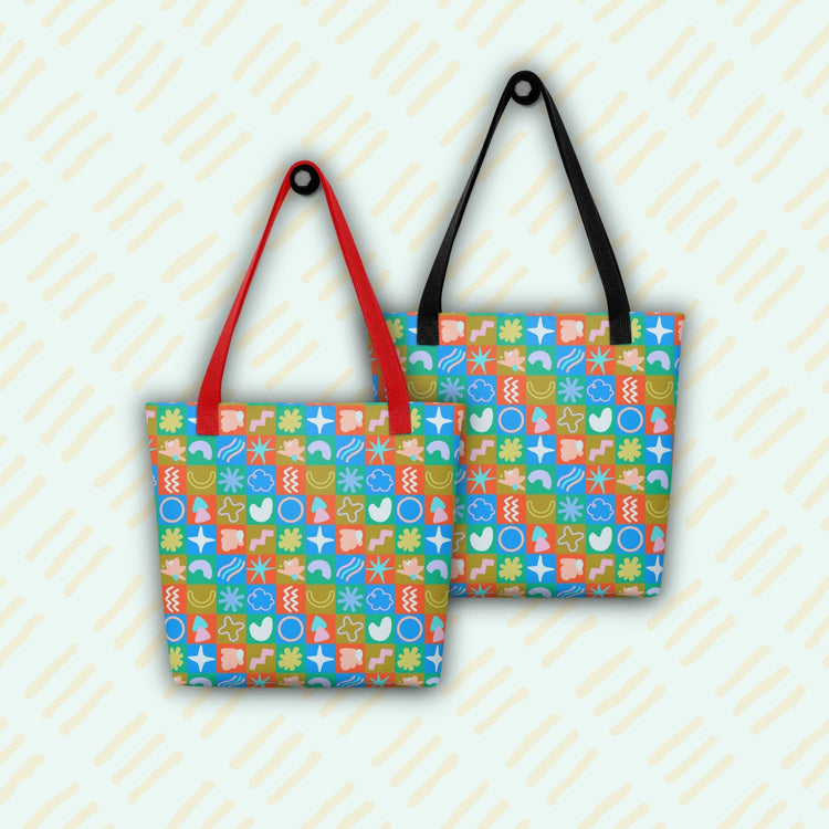 Two stylish Colour Block Tote Bags by My Favourite Colour is Rainbow feature vibrant patterns with shapes and symbols. The left bag has red handles, the right black handles. A light diagonal line pattern graces the background, enhancing elegance.