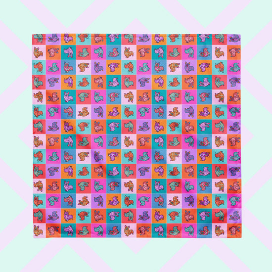 The Crazi Corgis Bandana by My Favourite Colour is Rainbow boasts a colorful grid pattern with abstract corgis in vibrant orange, purple, and turquoise hues.  The bandana is shown on a pastel geometric background.