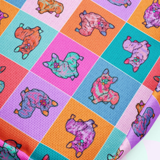 The Crazi Corgis Mini Crossbody Bag by My Favourite Colour is Rainbow features sturdy, colorful fabric with cartoon cats sporting exaggerated eyes and limbs. Its vibrant pink, orange, purple, and turquoise squares complement adjustable straps and a water-resistant design.