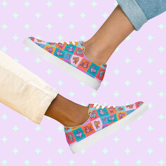 Two people relax back-to-back on a starry pastel background wearing vibrant Crazi Corgis Canvas Sneakers from My Favourite Colour is Rainbow. One pairs them with light blue rolled-up jeans, the other with beige pants.