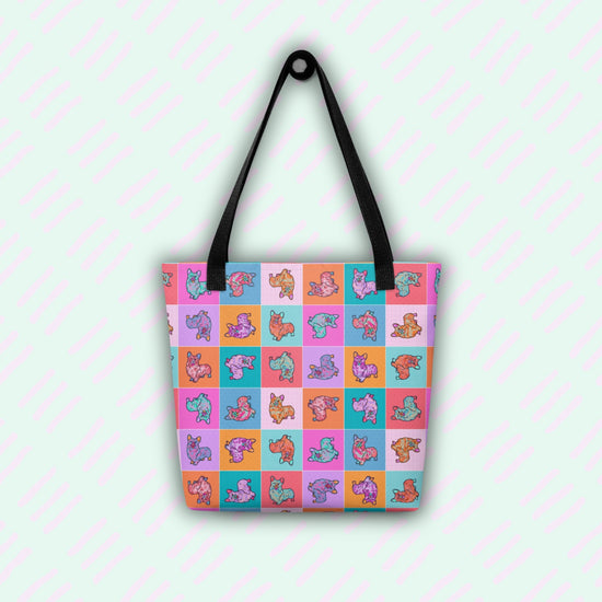 The Crazi Corgis Tote Bag by My Favourite Colour is Rainbow is a spacious, stylish accessory featuring black straps and a vibrant checkerboard pattern of cartoon foxes in purple, teal, and orange on a pastel backdrop. The playful design repeats across the front, making it a must-have.