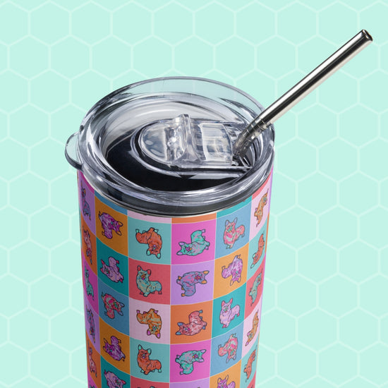 The Crazi Corgis Stainless Steel Tumbler by My Favourite Colour is Rainbow features a grid of square patches displaying vibrant cartoon dogs in various colors against a hexagonal mint green background, complete with a metal straw.