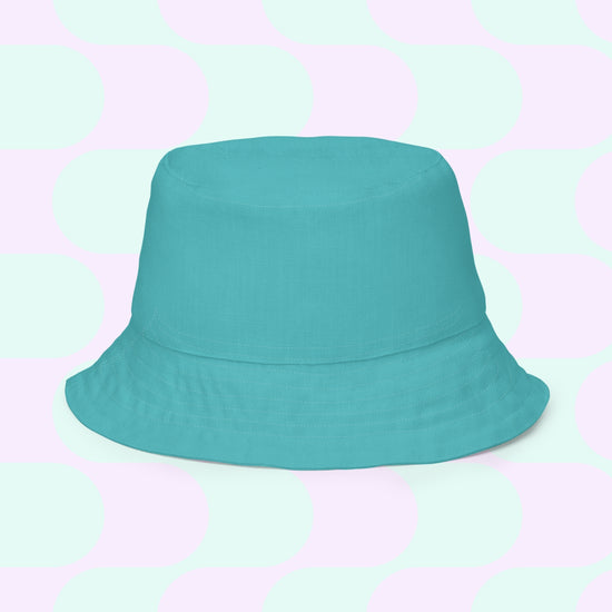 The Crazi Corgis Reversible Bucket Hat by My Favourite Colour is Rainbow, shown against overlapping light green and lavender circles, makes a stylish streetwear accessory.