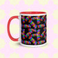 The Electric Zigzag Mug by My Favourite Colour is Rainbow features a vibrant zigzag pattern in pink, blue, green, orange, and purple on a black backdrop. A red handle and interior contrast with a pale yellow base with a subtle cross design—ideal for your coffee break!.