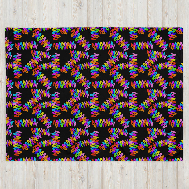 Discover the Electric Zigzag Throw Blanket by My Favourite Colour is Rainbow, featuring bold zigzag patterns in pink, orange, blue, green, and yellow on a black backdrop. This vibrant design creates a dazzling kaleidoscopic effect that enhances any space with its soft fabric charm.