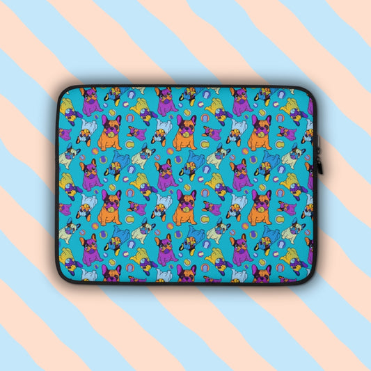 The Frenchie Fetch, Set, Match Laptop Sleeve by My Favourite Colour is Rainbow turns tech accessories into a statement piece with a print featuring purple, orange, yellow and blue french bulldogs and tennis balls on a blue backdrop. The print is on only one side of the laptop sleeve, the other side is black.