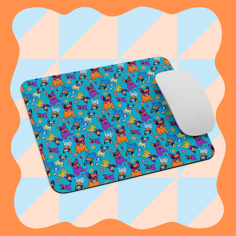 The Frenchie Fetch, Set, Match Mouse Pad by My Favourite Colour is Rainbow features a whimsical blue background with geometric patterns and orange wavy borders, showcasing playful cats and dogs. A white mouse rests on the pad.