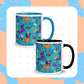 A set of two Frenchie Fetch, Set, Match Mug from My Favourite Colour is Rainbow, featuring cartoon French bulldogs in vibrant hues of orange and purple against a blue background with a peach and blue dotted border.