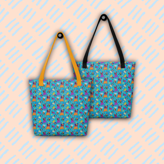 The Frenchie Fetch, Set, Match tote bags by My Favourite Colour is Rainbow feature colourful cartoon french bulldog and tennis ball designs on a bright blue background. One bag has yellow handles and the other black handles.