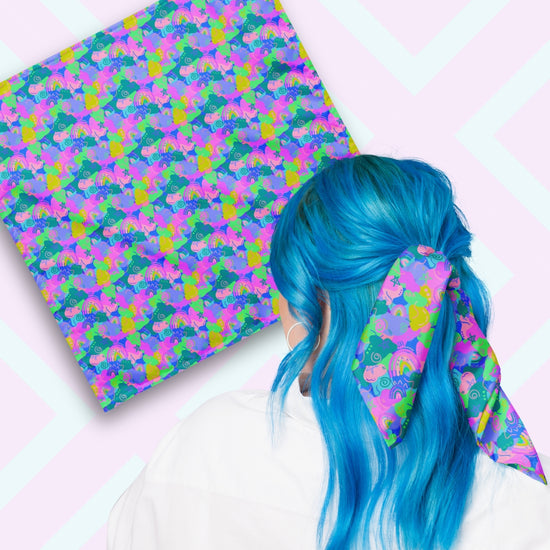 Two views of the 'Funfetti' Bandana by My Favourite Colour is Rainbow.  At top left, a flat lay of the bandana.  At bottom right, a person with vibrant blue hair is seen from behind, wearing the bandana in her hair.  The bandana features an abstract pattern with vibrant swirls, rainbows and stars in blue, pink, purple and green.