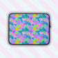 The Funfetti Laptop Sleeve by My Favourite Colour is Rainbow features a vibrant design of pink, green, blue, and purple rainbows, swirls and abstract shapes.  The print is on only one side of the laptop sleeve, the other side is black.