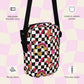 The Galaxy Mini Crossbody Bag by My Favourite Colour is Rainbow features a black and white checkered pattern with glittery gold, pink and red rainbows, stars, and hearts.  It includes a sturdy black strap, adjustable straps, two-way zipper, interior and exterior pockets, and durable fabric.