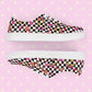 A pair of My Favourite Colour is Rainbows Galaxy Canvas Sneakers, decorated with a black and white checkerboard print, featuring gold, pink and red stars, hearts and rainbows.   They have white soles and laces.
