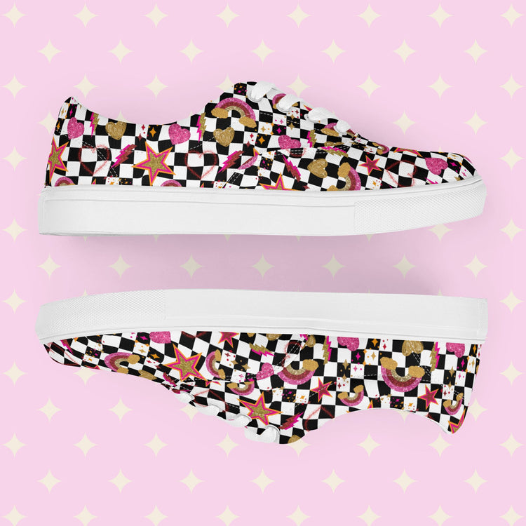 A pair of My Favourite Colour is Rainbows Galaxy Canvas Sneakers, decorated with a black and white checkerboard print, featuring gold, pink and red stars, hearts and rainbows.   They have white soles and laces.
