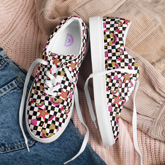 My Favourite Colour is Rainbows Galaxy Canvas Sneakers feature a vibrant print of stars, dice, and geometric shapes on a black and white checkered background. Theyre displayed atop cozy pink and beige sweaters, alongside denim jeans.