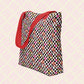 The Galaxy Tote Bag by My Favourite Colour is Rainbow is a spacious tote featuring a red strap and decorated with a black-and-white checkerboard pattern with stars, rainbows and hearts in glittery gold, pink and red.