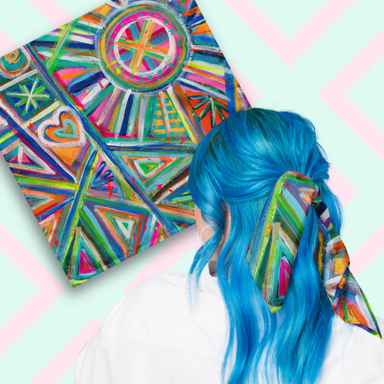 Two views of the 'Geometric Rainbow' Bandana by My Favourite Colour is Rainbow.  At top left, a flat lay of the bandana.  At bottom right, a person with vibrant blue hair is seen from behind, wearing the bandana in her hair.  The bandana features a vibrant abstract design with triangles, circles, and hearts in pink, blue, green, and orange.