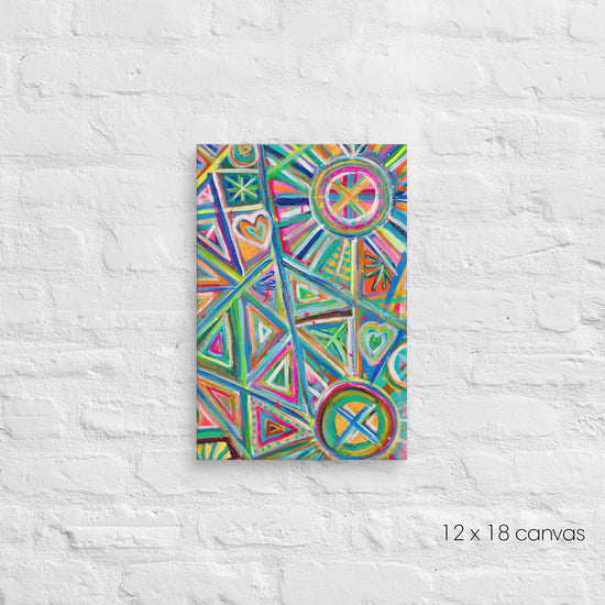 A 12x18 Geometric Rainbow canvas by My Favourite Colour is Rainbow, featuring vibrant triangles, hearts and circles in pink, blue, green, and orange, is mounted on a textured white background.