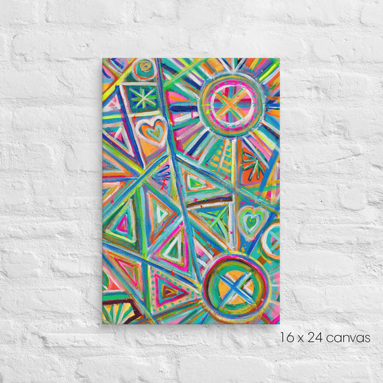 A 16x24 Geometric Rainbow canvas by My Favourite Colour is Rainbow, featuring vibrant triangles, hearts and circles in pink, blue, green, and orange, is mounted on a textured white background.