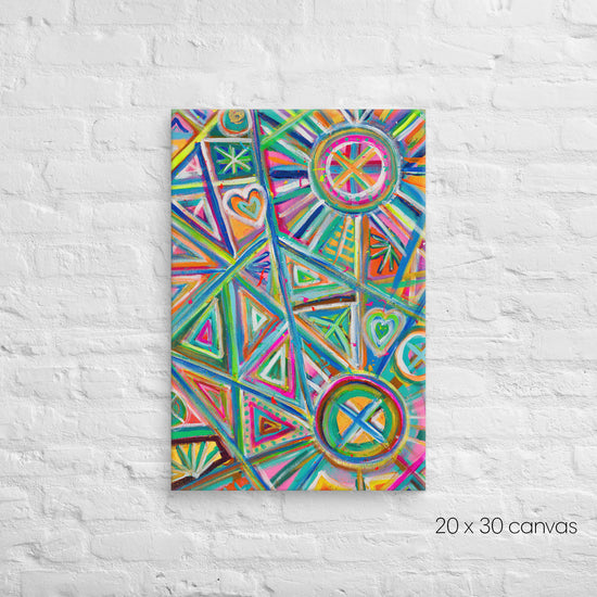 A 20x30 Geometric Rainbow canvas by My Favourite Colour is Rainbow, featuring vibrant triangles, hearts and circles in pink, blue, green, and orange, is mounted on a textured white background.