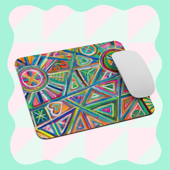 The Geometric Rainbow Mouse Pad by My Favourite Colour is Rainbow, showcasing vibrant geometric patterns, rests on a pastel checkered background with a white mouse positioned on the right side.